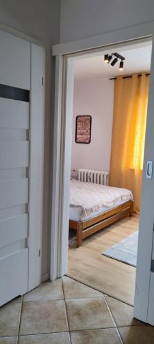 a bedroom with a bed in a room at Apartament Lubin in Lubin