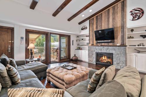 a living room with a couch and a fireplace at Lodge at Lionshead 403 in Vail