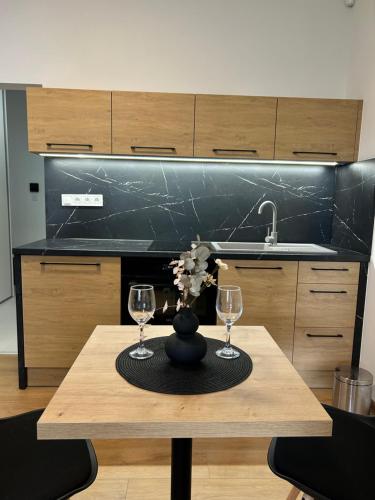 a table with two wine glasses on it in a kitchen at AR TAHITI black in Košice