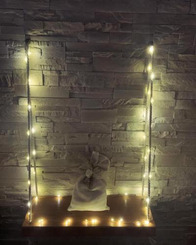a cake with a bow on a shelf with lights at Vittò in Martina Franca
