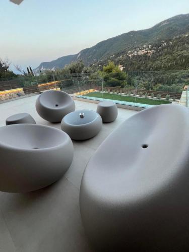 a row of white benches sitting on top of a building at Mylos ridge villas - ORION in Agios Nikitas
