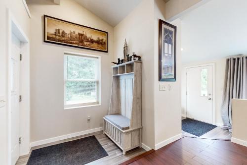a living room with a chair and a window at Stucco House in North Hudson