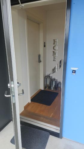 an open door leading into a room with a staircase at City housing in Stavanger