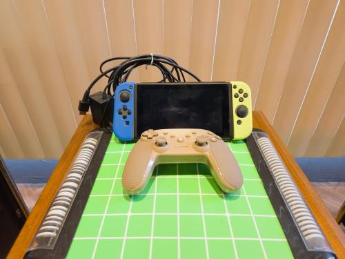 a video game controller sitting on top of a table at アワセベイストリートホテル in Okinawa City