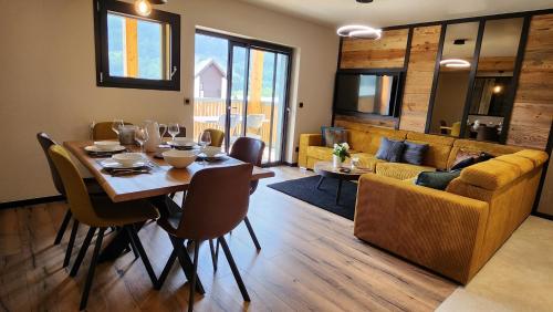 une salle à manger avec une table et un canapé dans l'établissement Les Ô d'Ulysse, à Bourg-Saint-Maurice