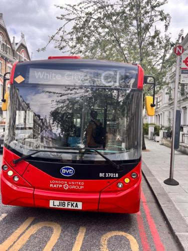 a red bus parked on the side of a street at Holland Inn Hotel in London