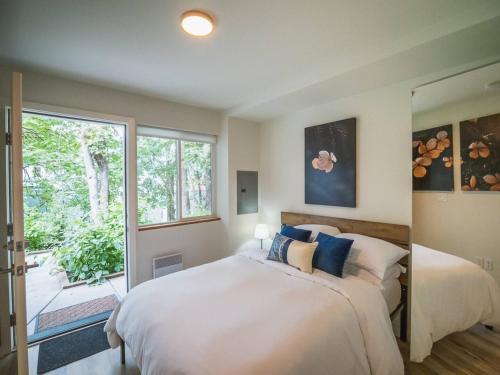 a bedroom with a large bed and a window at "Sauna-fication" in West Seattle in Seattle