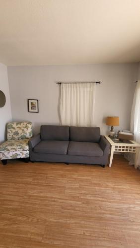 a living room with a blue couch in front of a window at Unit 5 - Stay at Roosevelt Row Modern 2BR 2BA Condo in Phoenix