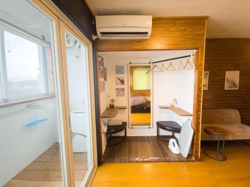 a small room with a bathroom and a bedroom at アワセベイストリートホテル in Okinawa City