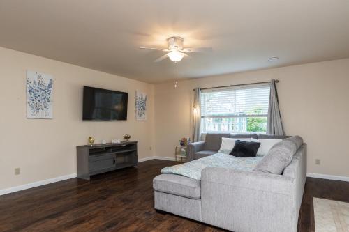 a living room with a couch and a tv at Birch Hill Homestay in Fairbanks