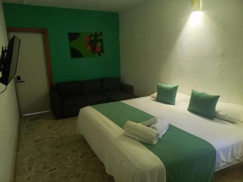 Ένα ή περισσότερα κρεβάτια σε δωμάτιο στο Hotel Casa Olga