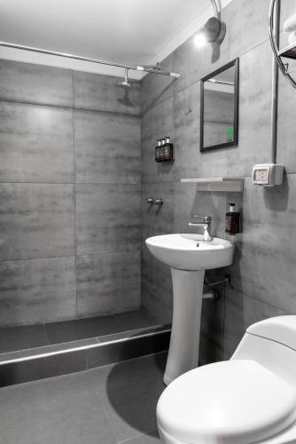 a bathroom with a white sink and a toilet at qema Arequipa in Arequipa