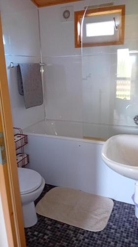 a bathroom with a tub and a toilet and a sink at Baytree Lodge at three lochs holiday park, NEW ASK ABOUT OUR PACKAGES birthday ,anniversary,family,pamper packages available in Balminnoch