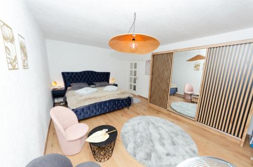 a bedroom with a bed and a living room at Apartment Center Korzo in Bihać