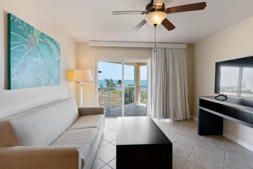 a living room with a couch and a flat screen tv at Holiday Inn Resort Grand Cayman by IHG in George Town