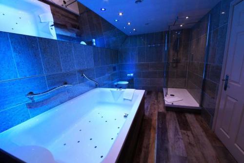 a large bathroom with a tub and a shower at Best Western Premier Doncaster Mount Pleasant Hotel in Doncaster