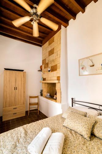 a bedroom with a bed and a wooden ceiling at Mary's house Lindos in Lindos