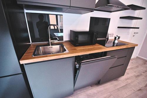 a kitchen counter with a sink and a microwave at Tigullio Nest Rapallo in Rapallo
