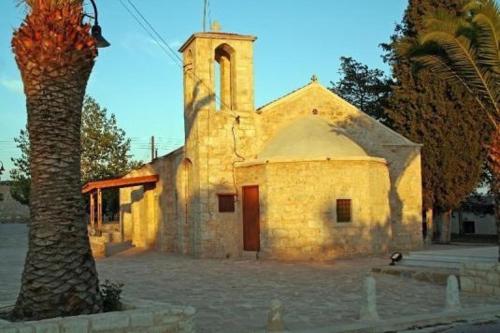 an old stone church with a tree in front of it at Arodes AsteriA Volunteer & Youth ECO-house in Paphos City