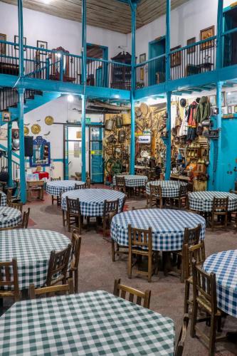 a dining room with tables and chairs in a room at Hotel El Tesoro Sonson in Sonsón