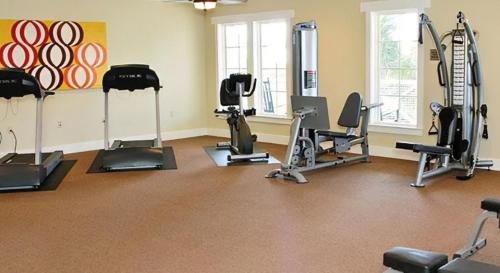 a gym with several exercise equipment in a room at Reel Memories in St. George Island