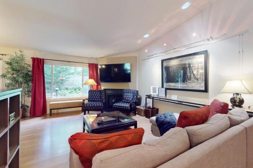 a living room with a couch and a table at Forest Retreat in Shoreline