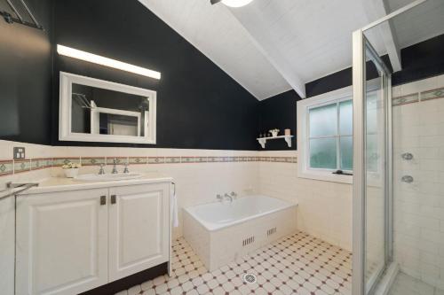 a bathroom with a sink and a tub and a toilet at Our Glenbogle in Medlow Bath