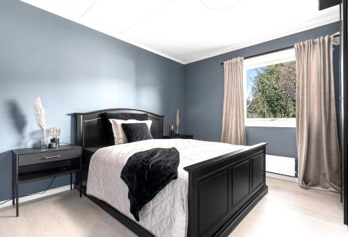 a bedroom with a black bed and a window at Guest room in Lucan