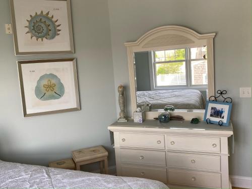 a bedroom with a dresser and a mirror at Watch Hill, RI Luxury Penthouse Rental Ocean View & Rooftop Deck in Westerly