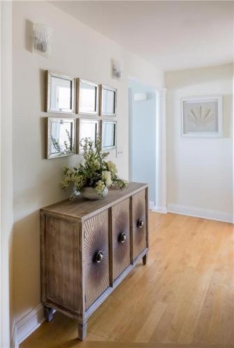 a room with a wooden cabinet with a plant on it at Watch Hill, RI Luxury Penthouse Rental Ocean View & Rooftop Deck in Westerly