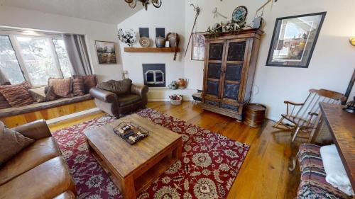 a living room with a couch and a coffee table at Thornes Downtown Delight - WiFi - Satellite - Washer - Dryer - Fireplace - Fenced In Back Yard in Red River