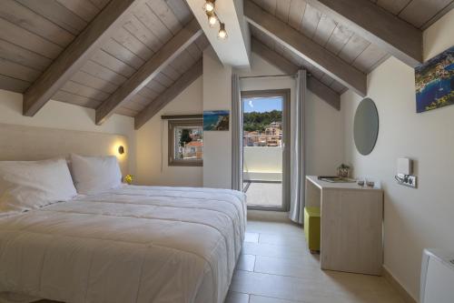 a bedroom with a large bed and a large window at AM Suites Kefalonia in Argostoli