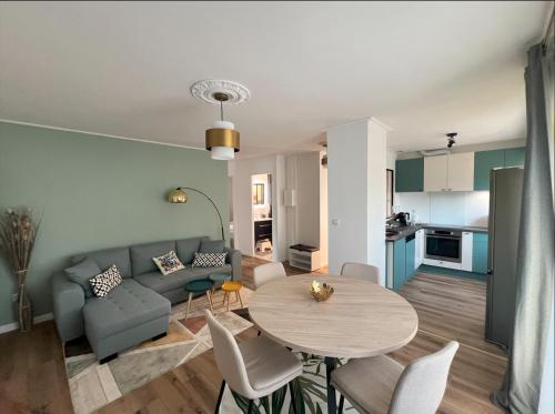 a living room with a table and a couch at Belle maison avec jardin ! in Bezannes-les-Reims