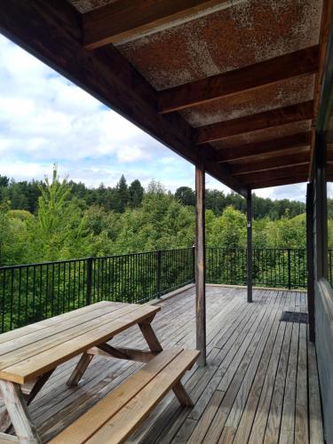 a wooden deck with a bench on top of it at 3 Scarborough Terrace in Hanmer Springs