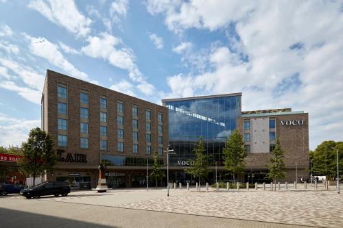 a large building with a car parked in front of it at voco Leicester by IHG in Leicester