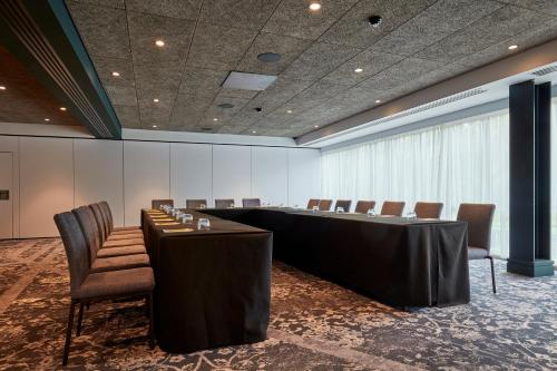 a conference room with a long table and chairs at voco Leicester by IHG in Leicester