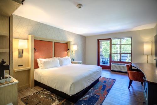 a hotel room with a bed and a desk and a desk at The Embers Hotel in Blowing Rock