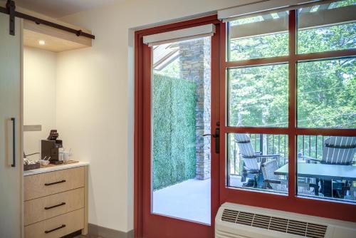 a sliding glass door leading to a patio with a table at The Embers Hotel in Blowing Rock