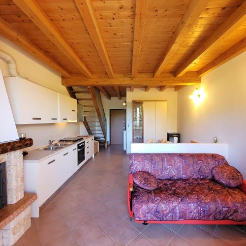 a living room with a couch and a kitchen at Mountain Lake Endine- Iseo Milly's Home in Bianzano