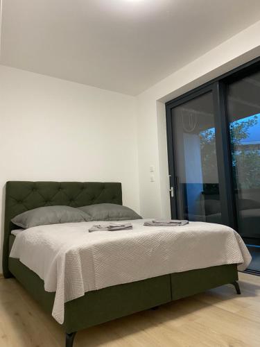 a bedroom with a large bed with white sheets at AR MYKONOS oasis in Košice