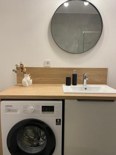 a bathroom with a washing machine and a sink at AR MYKONOS oasis in Košice