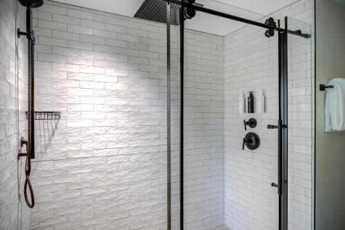 a bathroom with a shower with a glass door at The Embers Hotel in Blowing Rock