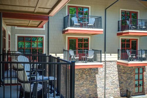 a patio with chairs and tables on a building at The Embers Hotel in Blowing Rock
