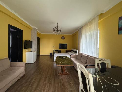 a living room with a couch and a table at Royal House in Kvariati