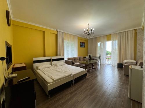 a bedroom with a bed and a living room at Royal House in Kvariati