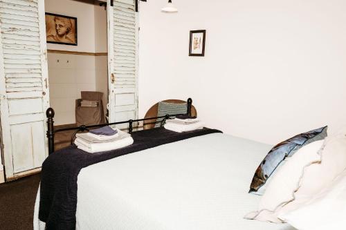 a bedroom with a large white bed in a room at The Wimberley - Stay in the heart of town Goomeri! in Goomeri