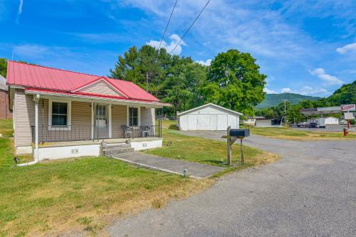 a small house with a red roof on a street at Cozy Tazewell Home with Grill on Back of the Dragon! in Tazewell