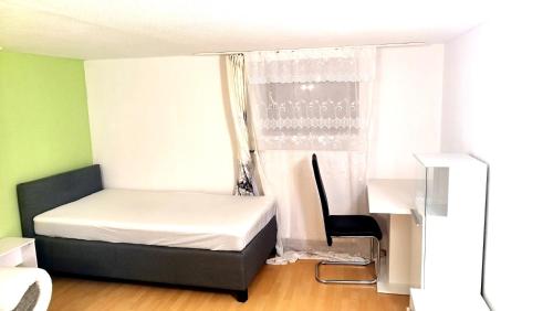 a small bedroom with a bed and a window at Ferienwohnung in Friedberg für max 9 Personen im UG in Friedberg