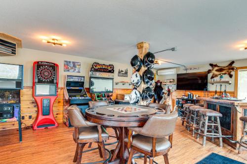 a room with a table and chairs and a video game at Northwood Tours Escape with Boat Dock Access! in Minocqua