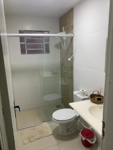 a bathroom with a shower and a toilet and a sink at Pousada Le Sorelle apt03 in Rosário do Sul
